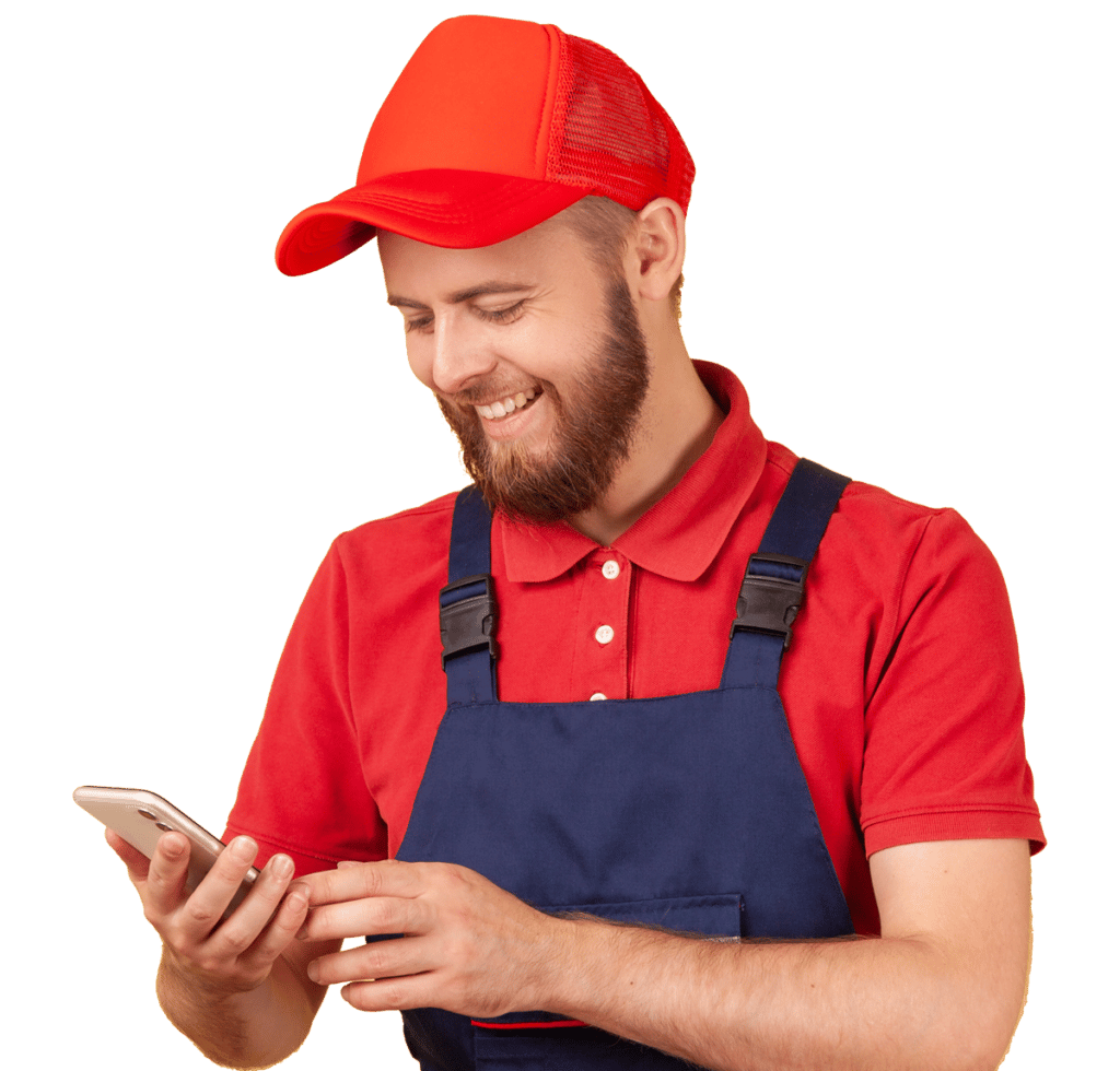 Smiling courier or craftsman standing with with smartphone